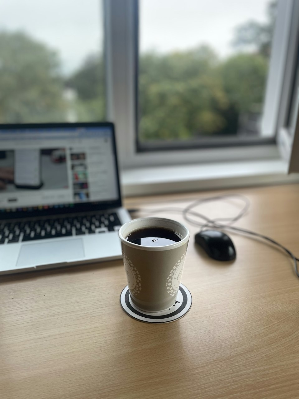 A quiet desk with a laptop and a cup of coffee — editorial illustration