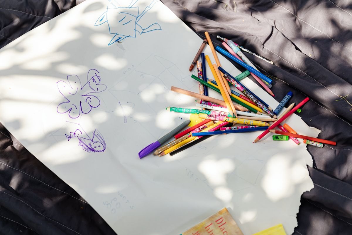 Coloring materials and paper in dappled natural light.