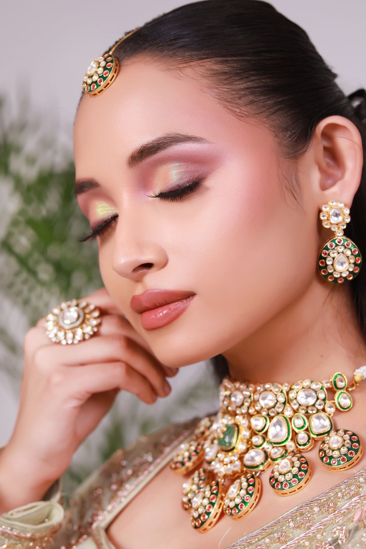 Close-up portrait of an elegant Indian bride showcasing traditional jewelry and makeup.