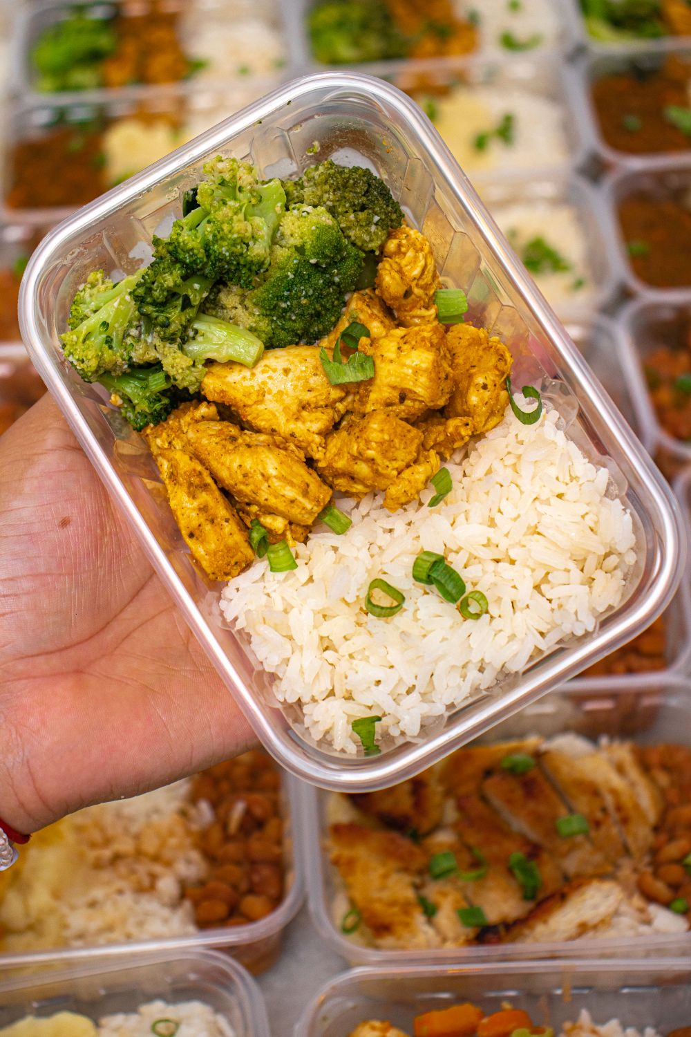 Chicken, rice and broccoli in a meal prep container.
