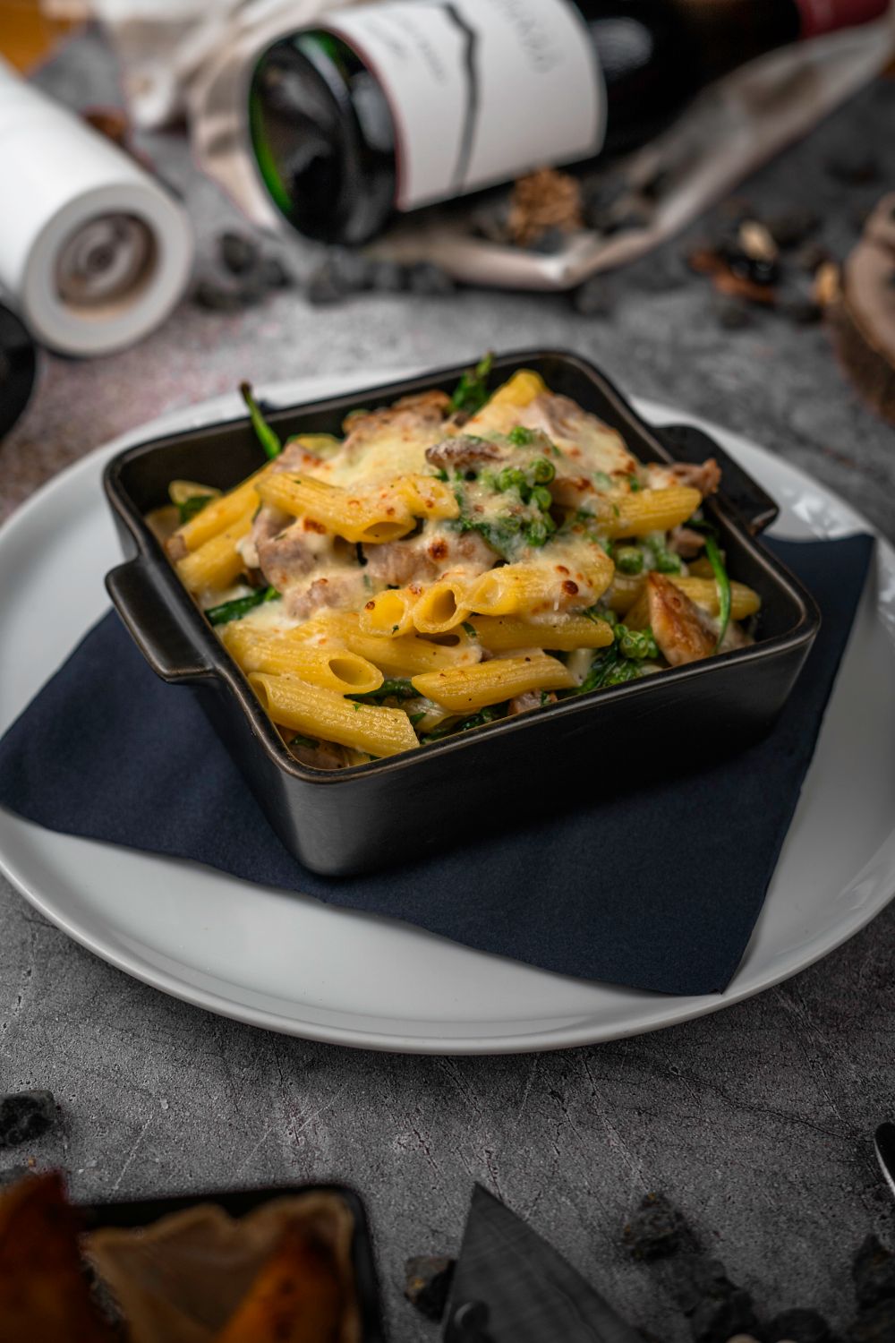 Baked pasta with melted cheese, tomato sauce and vegetables.