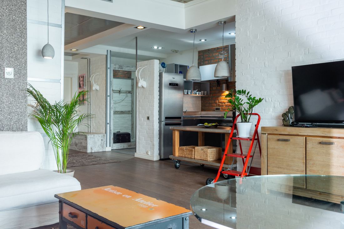 A bright living room connected to a kitchen.