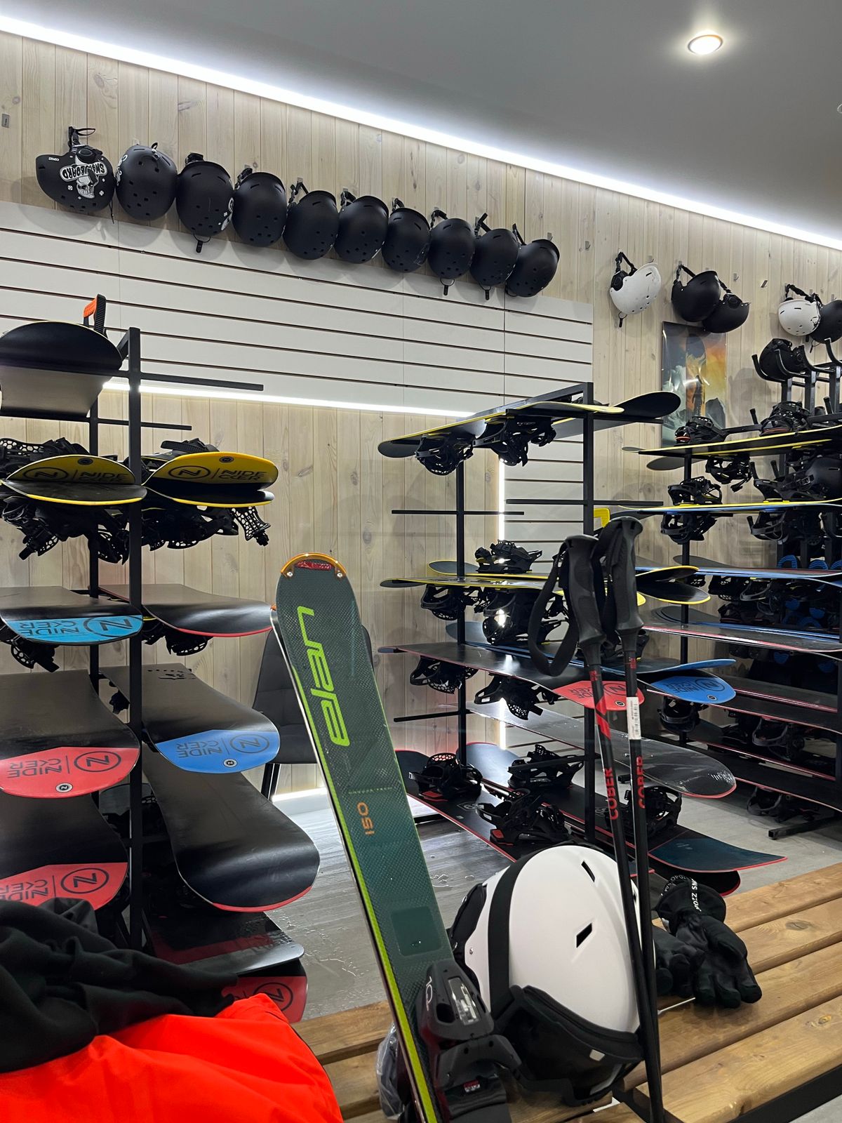 Interior view of a ski and snowboard shop with various equipment on display.