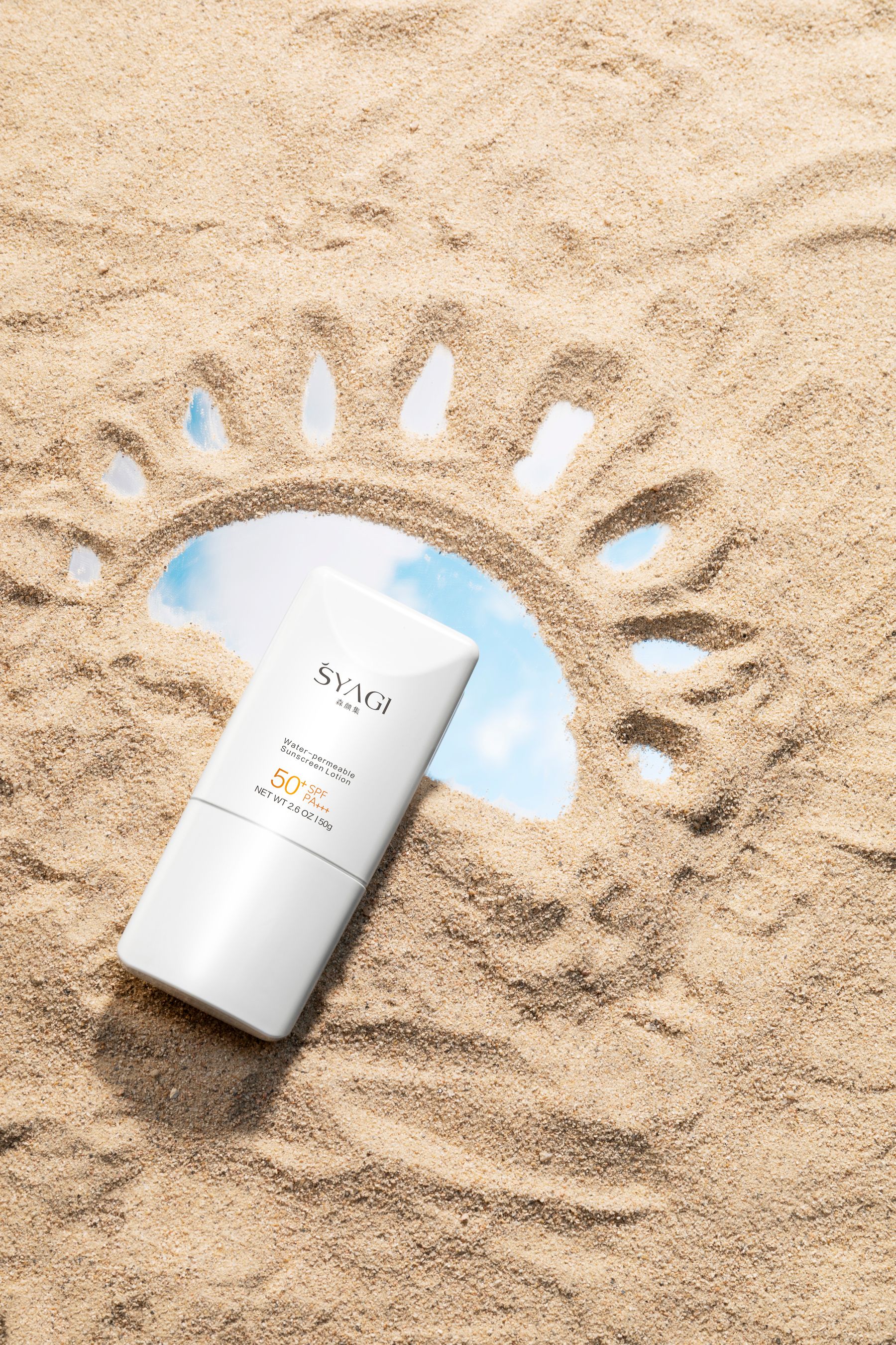 White SPF50 sunscreen bottle displayed on sand