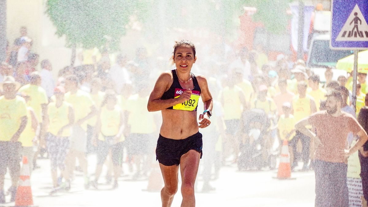 Woman running in a road race in daylight.