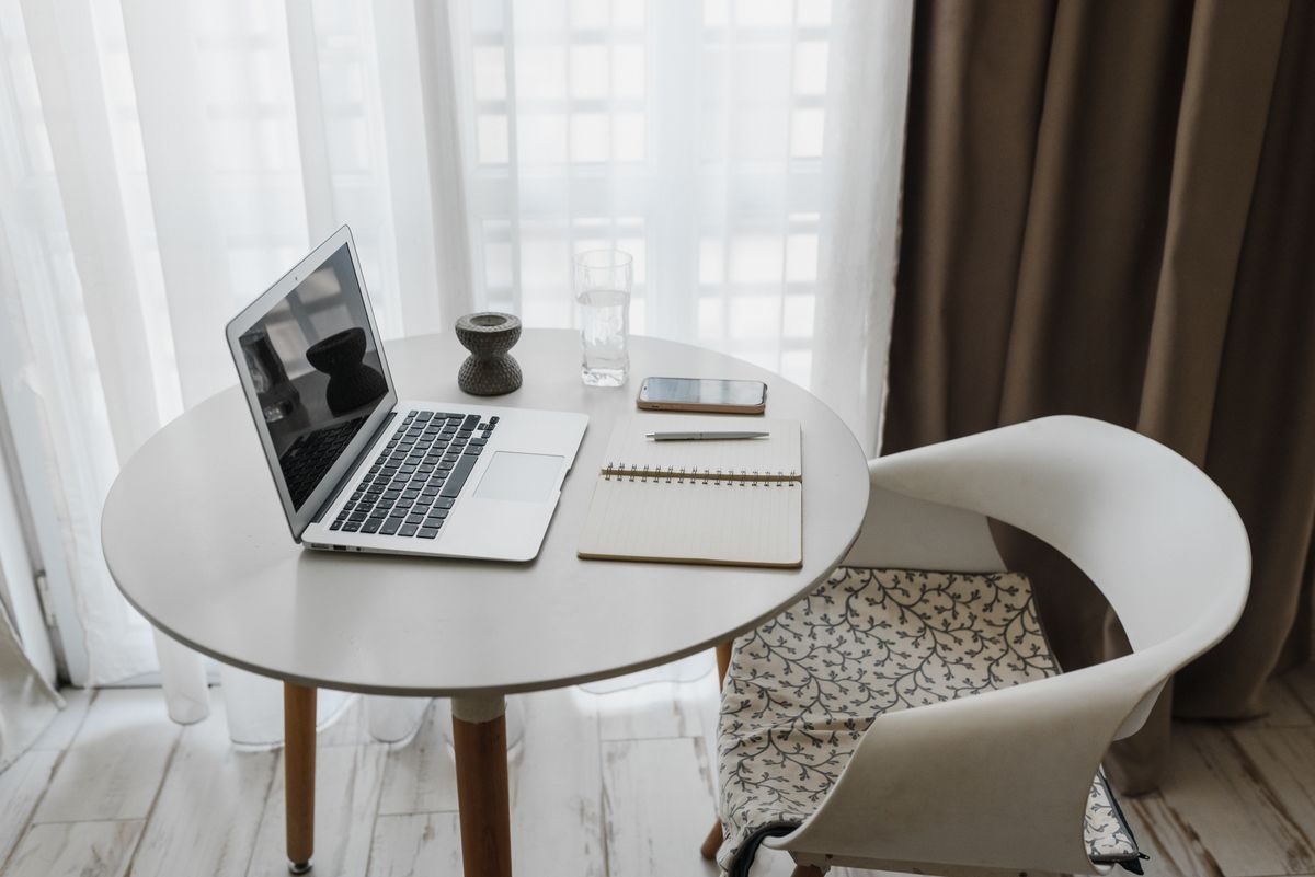 Laptop, notebook and phone on a table.