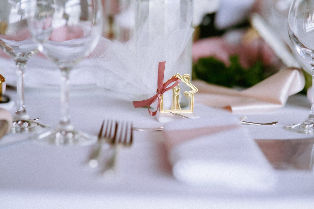 A beautifully arranged wedding table with elegant cutlery and glassware, adorned with decorative elements.